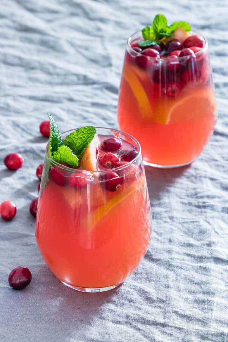 two glasses of christmas punch on a table