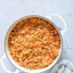 top-down view of Cinnamon Spiced Jollof Rice in a white pot