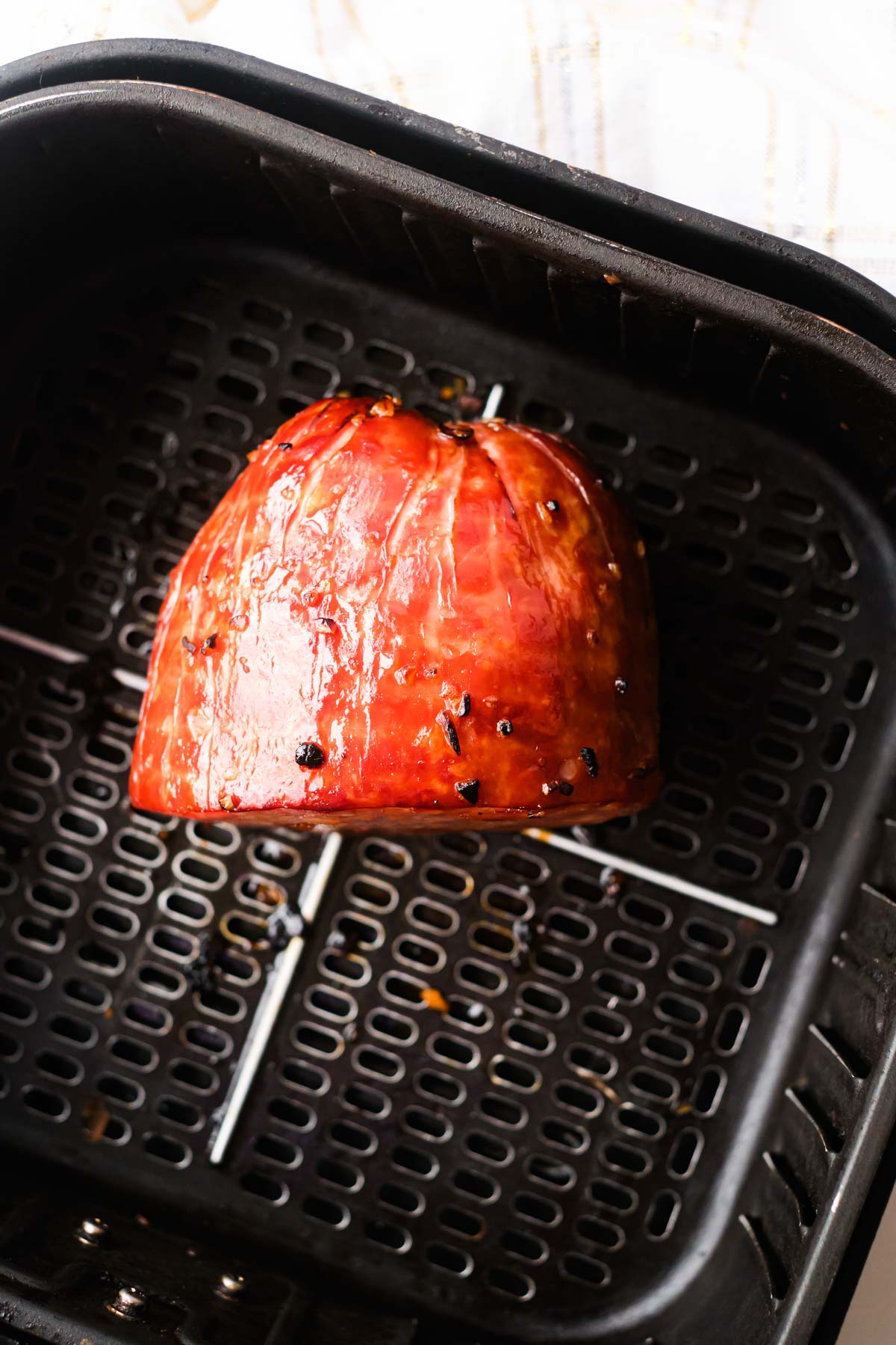 close up view of the air fryer ham inside the air fryer basket
