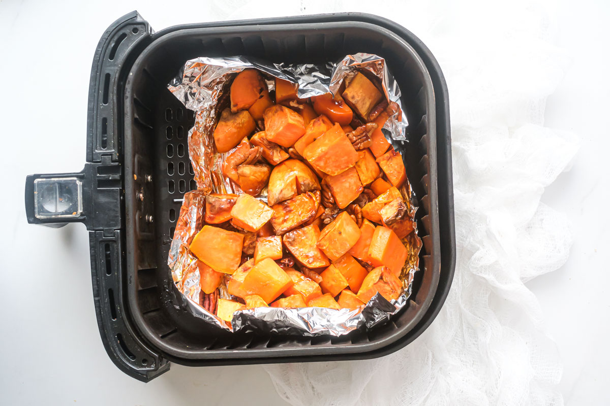 top down view of the completed air fryer sweet potato cubes inside the air fryer basket