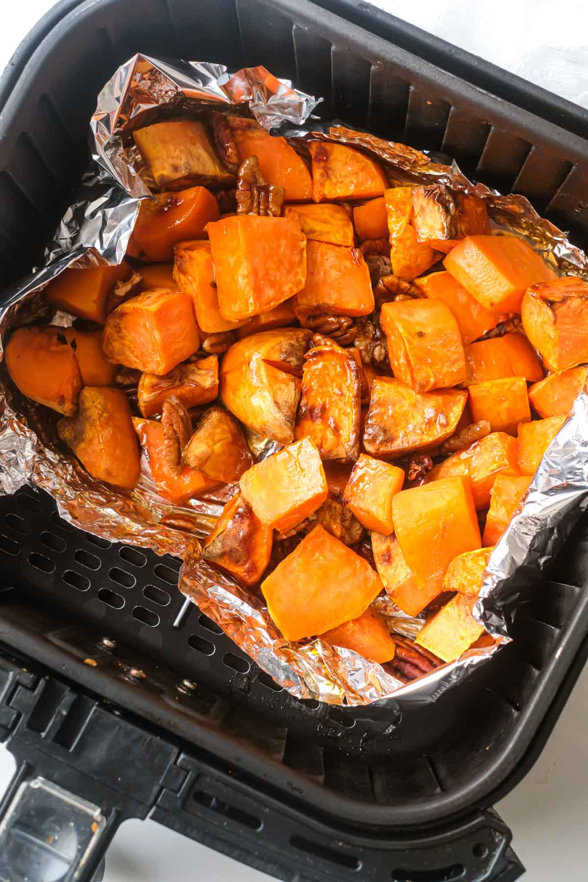 top down view of the completed air fryer sweet potato cubes inside the air fryer basket
