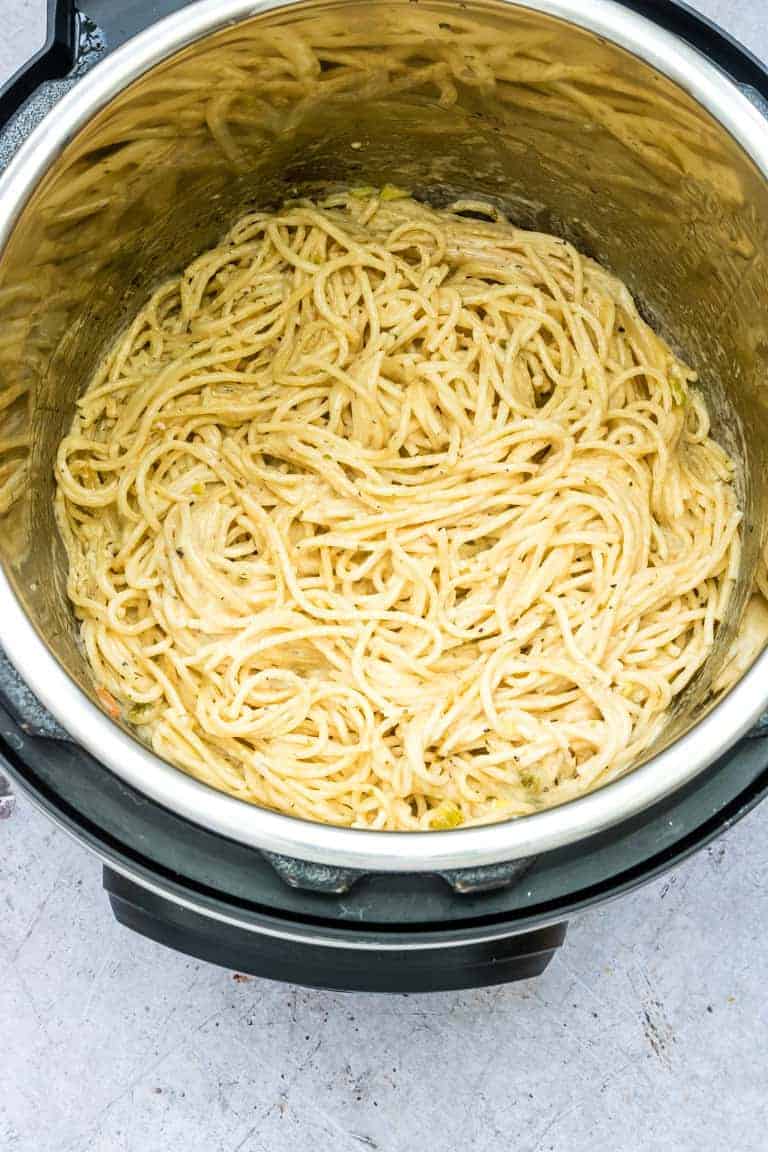 Instant Pot Spaghetti with a cheesy garlic butter sauce inside the Instant Pot