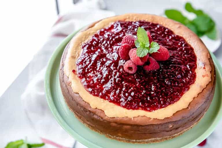 close up of keto cheesecake with raspberry jam