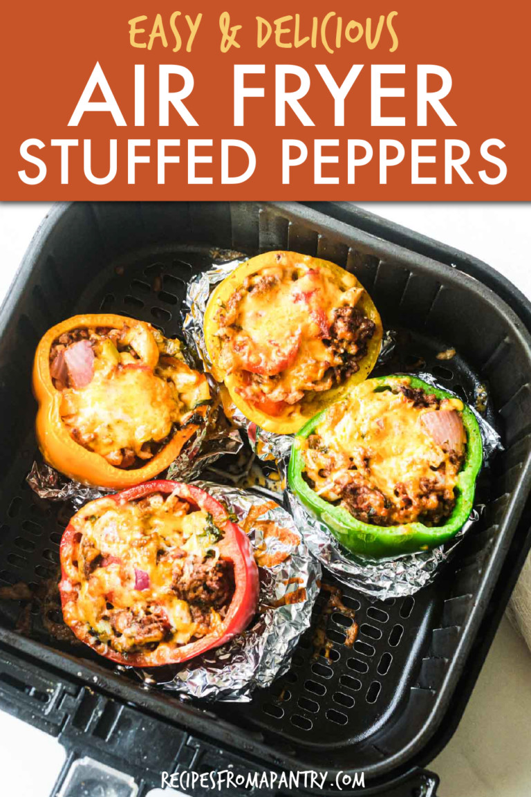 four stuffed peppers in an air fryer basket