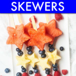 FOUR FRUIT SKEWERS ON A PLATE MADE OF FRUIT CUT IN STAR SHAPES WITH BERRIES