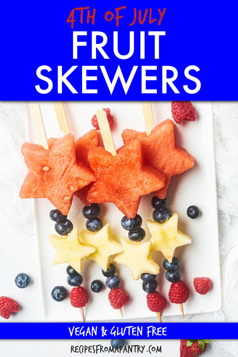 FOUR FRUIT SKEWERS ON A PLATE MADE OF FRUIT CUT IN STAR SHAPES WITH BERRIES