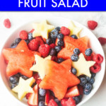 A BOWL OF FRUIT CUT INTO STAR SHAPES WITH BERRIES