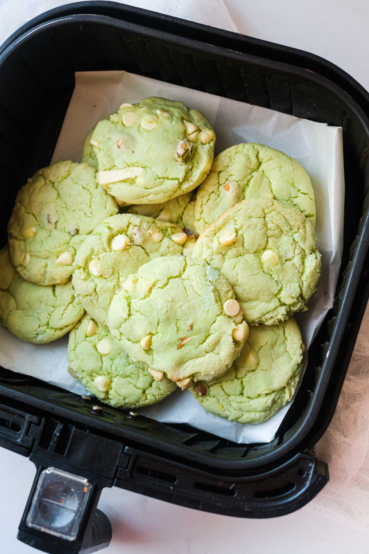 the completed air fryer pistachio pudding cookies inside the air fryer basket