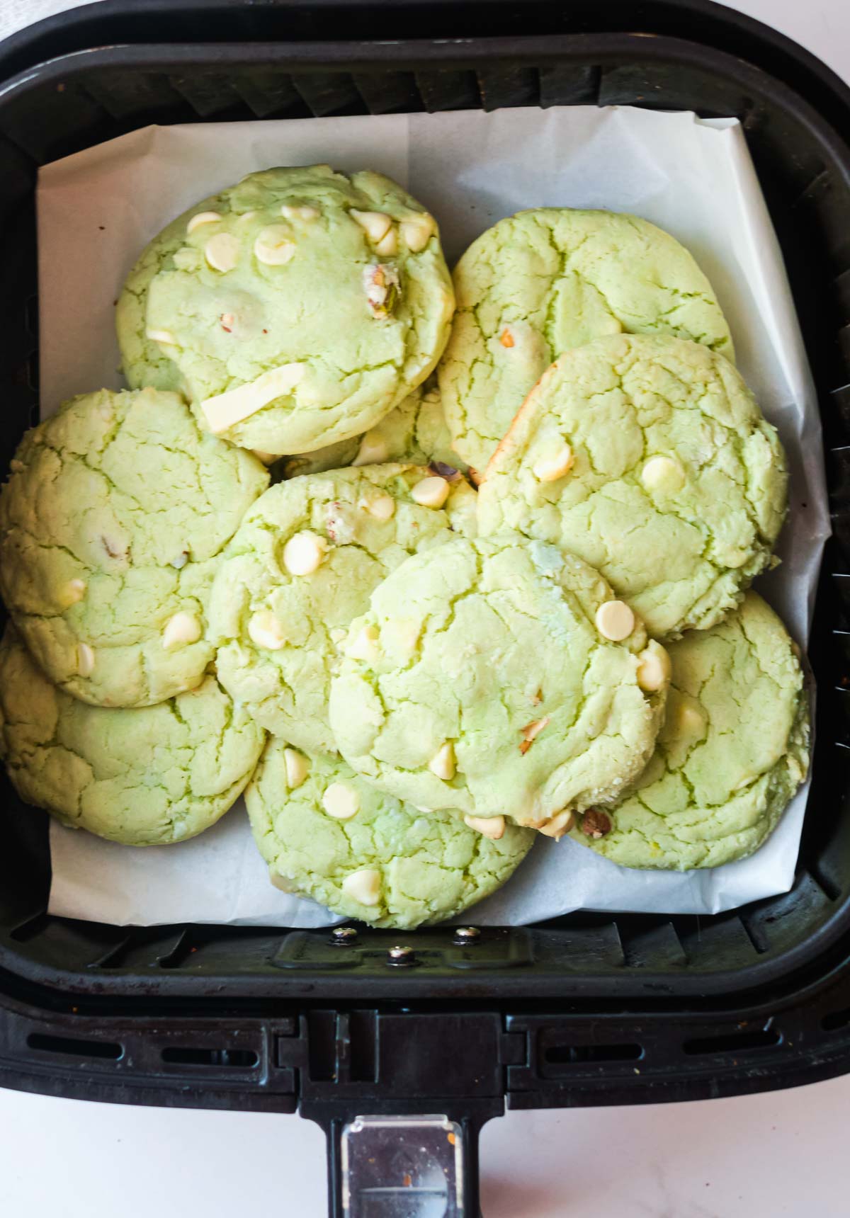 baked air fryer pistachio pudding cookies inside the air fryer basket