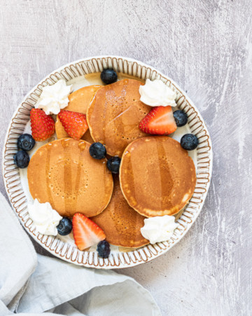 air fryer frozen pancakes served with whipped cream and berries