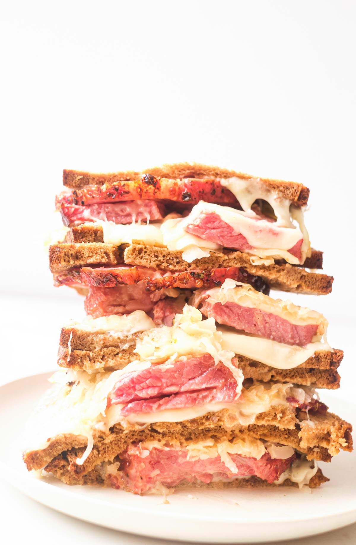 air fryer reuben sandwich halves stacked on top of one another