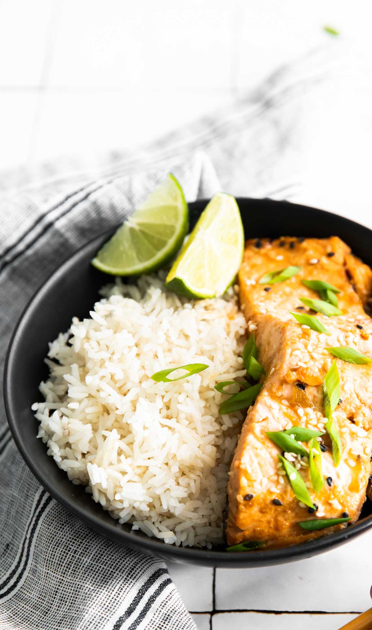 one portion of instant pot salmon served with rice and lime wedges.
