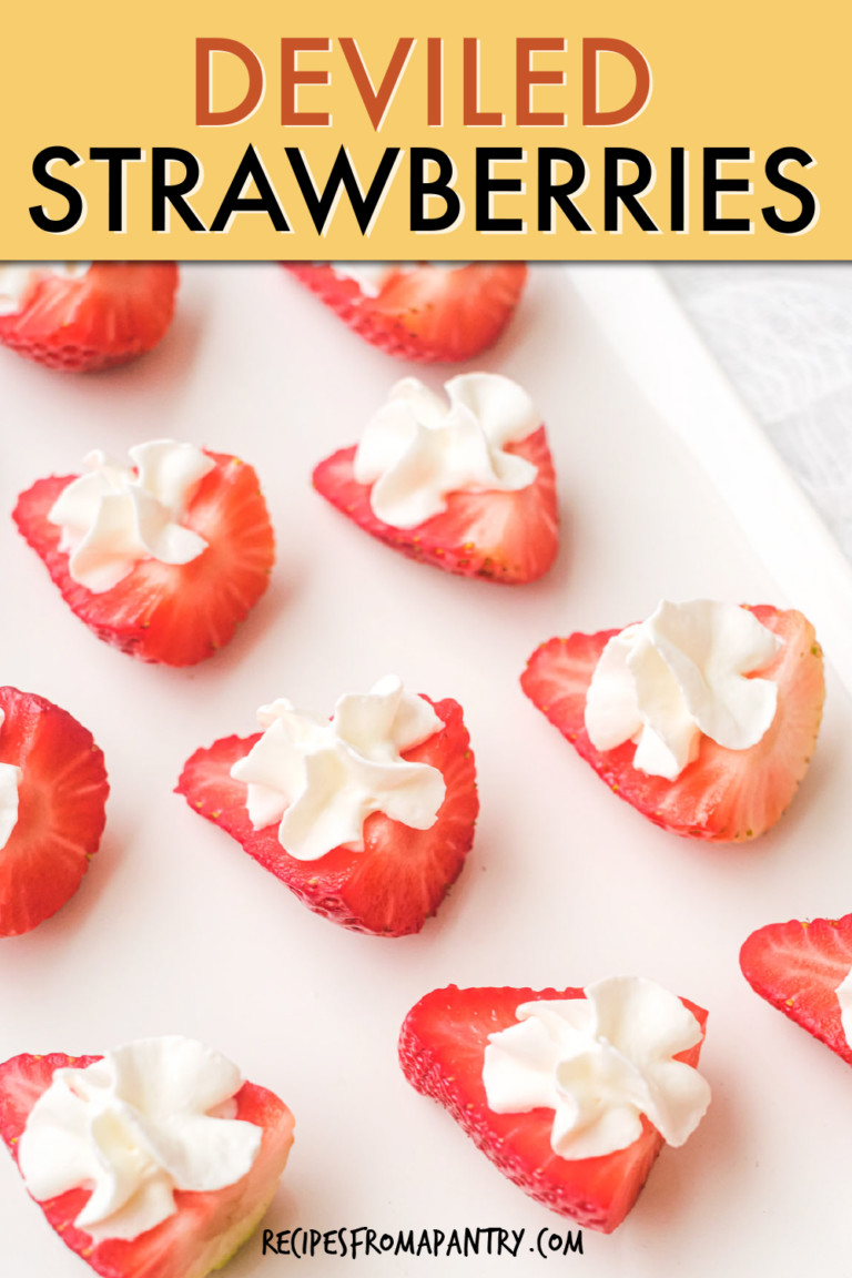 close up of halved strawberries filled with whipped cream