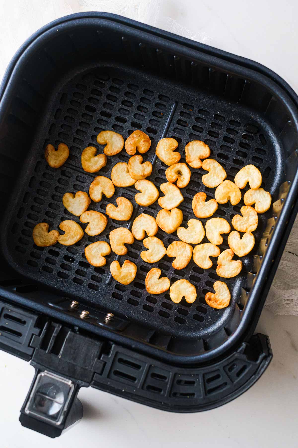 top down view of the finished heart potatoes in air fryer basket