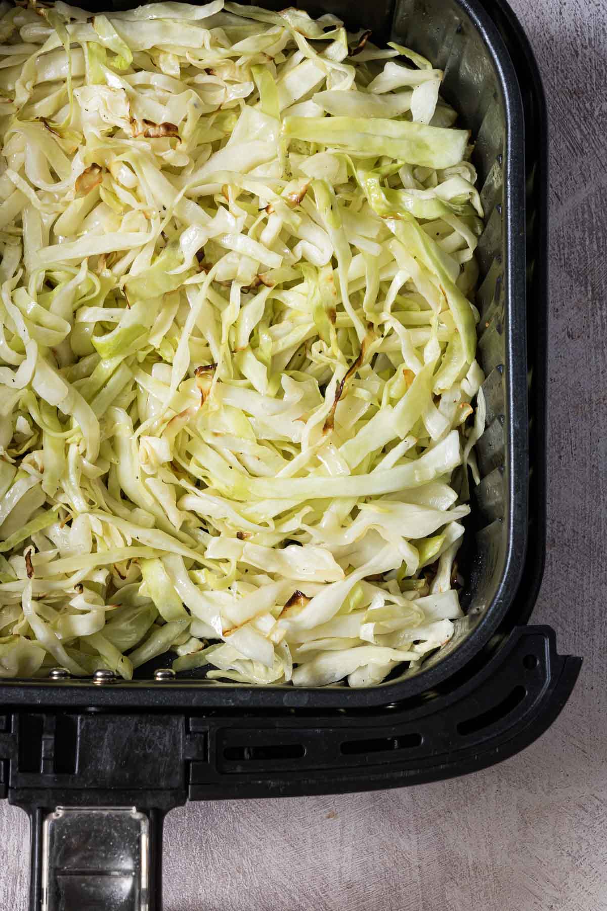 top down view of the air fryer cabbage inside the air fryer basket.