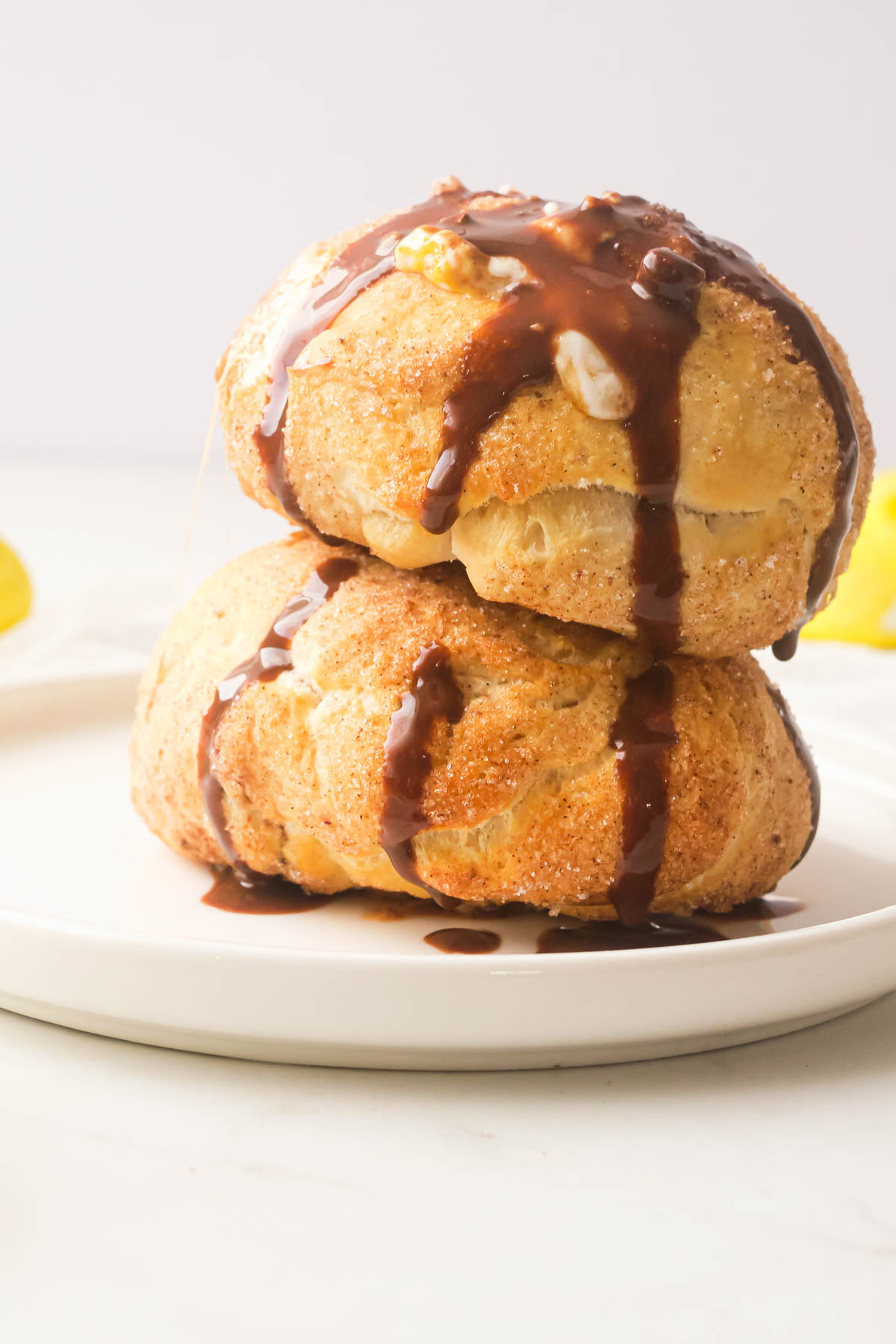 two air fryer peeps rolls stacked on top of each other and topped with chocolate sauce