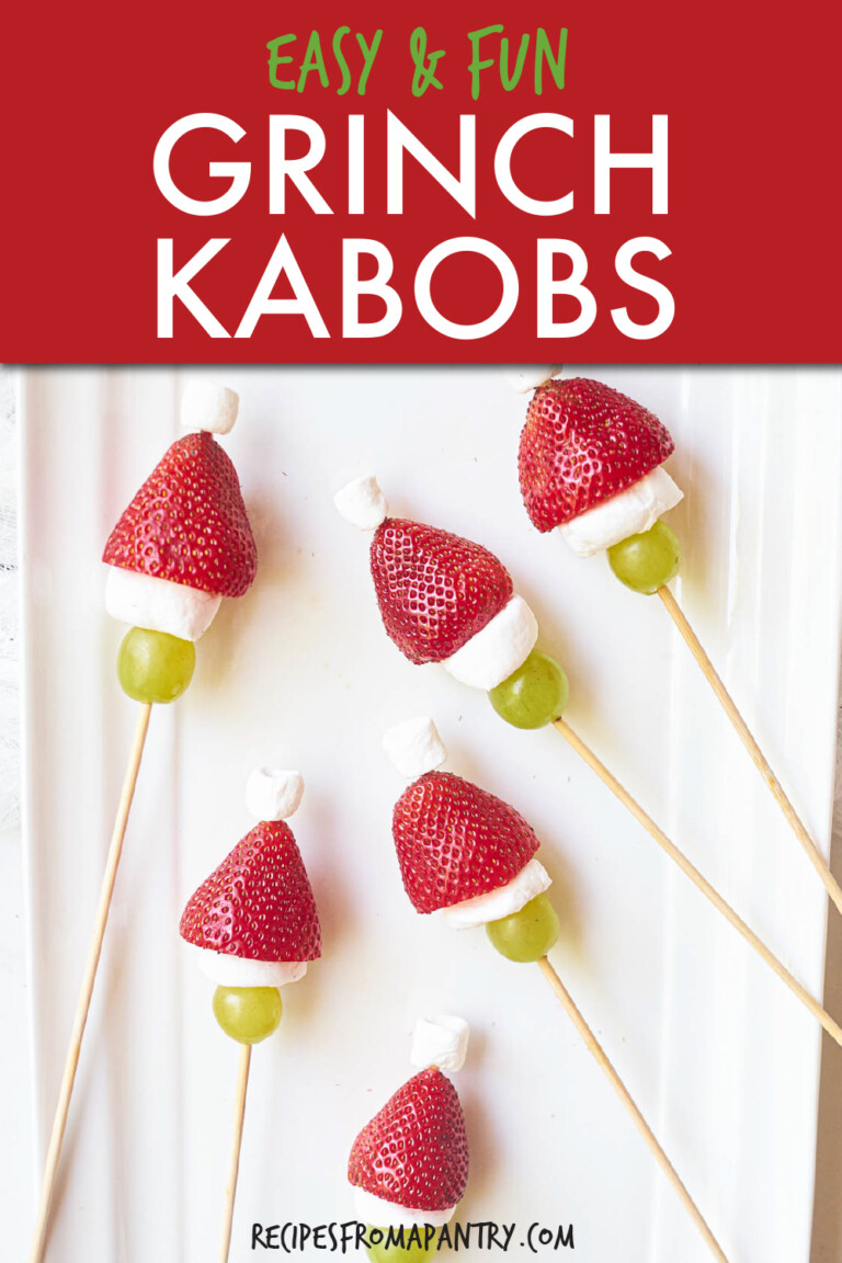 skewers made of strawberries, marshmallows and grapes on a plate