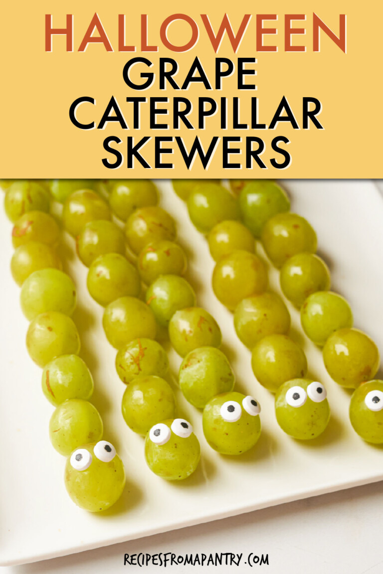A row of 5 grape skewers with eyes that look like caterpillars