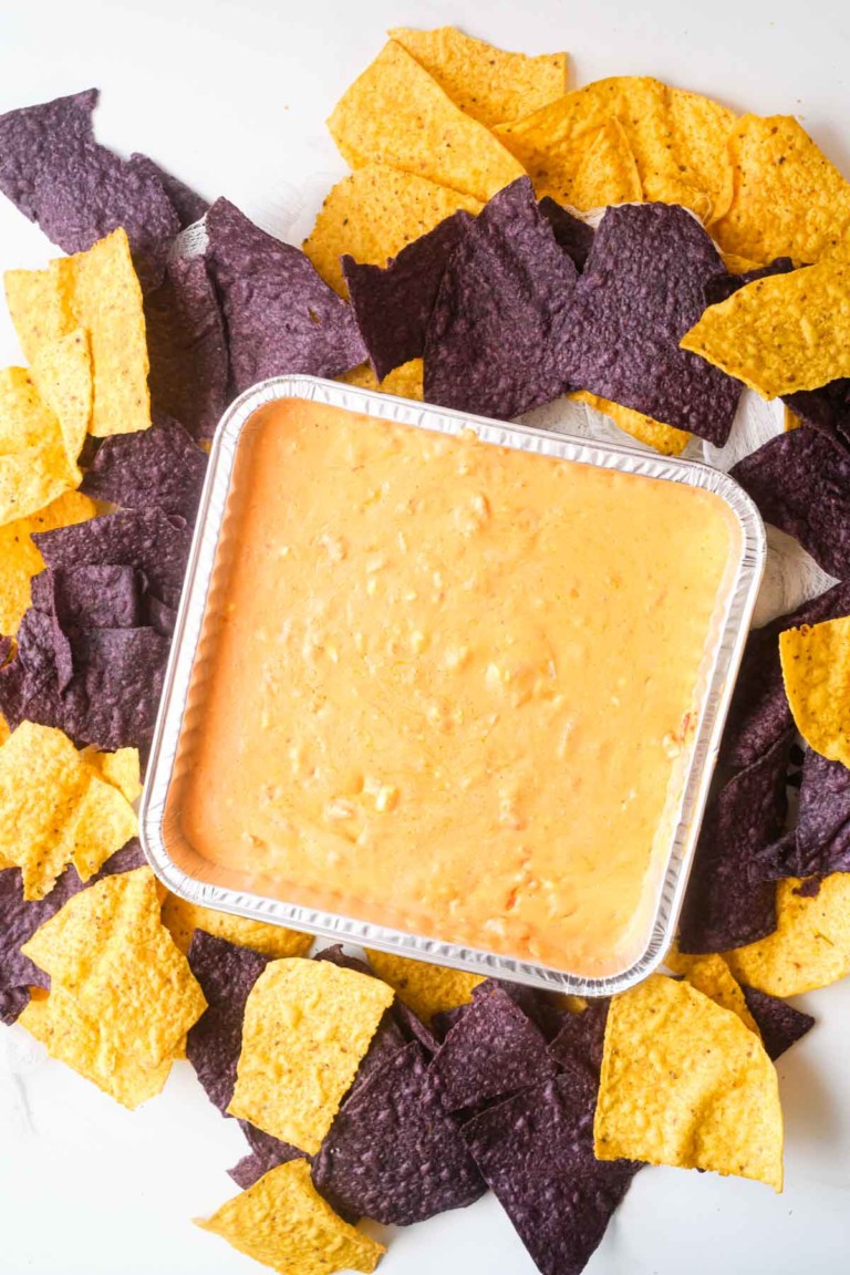 the completed air fryer mexican cheese dip surrounded by tortilla chips.