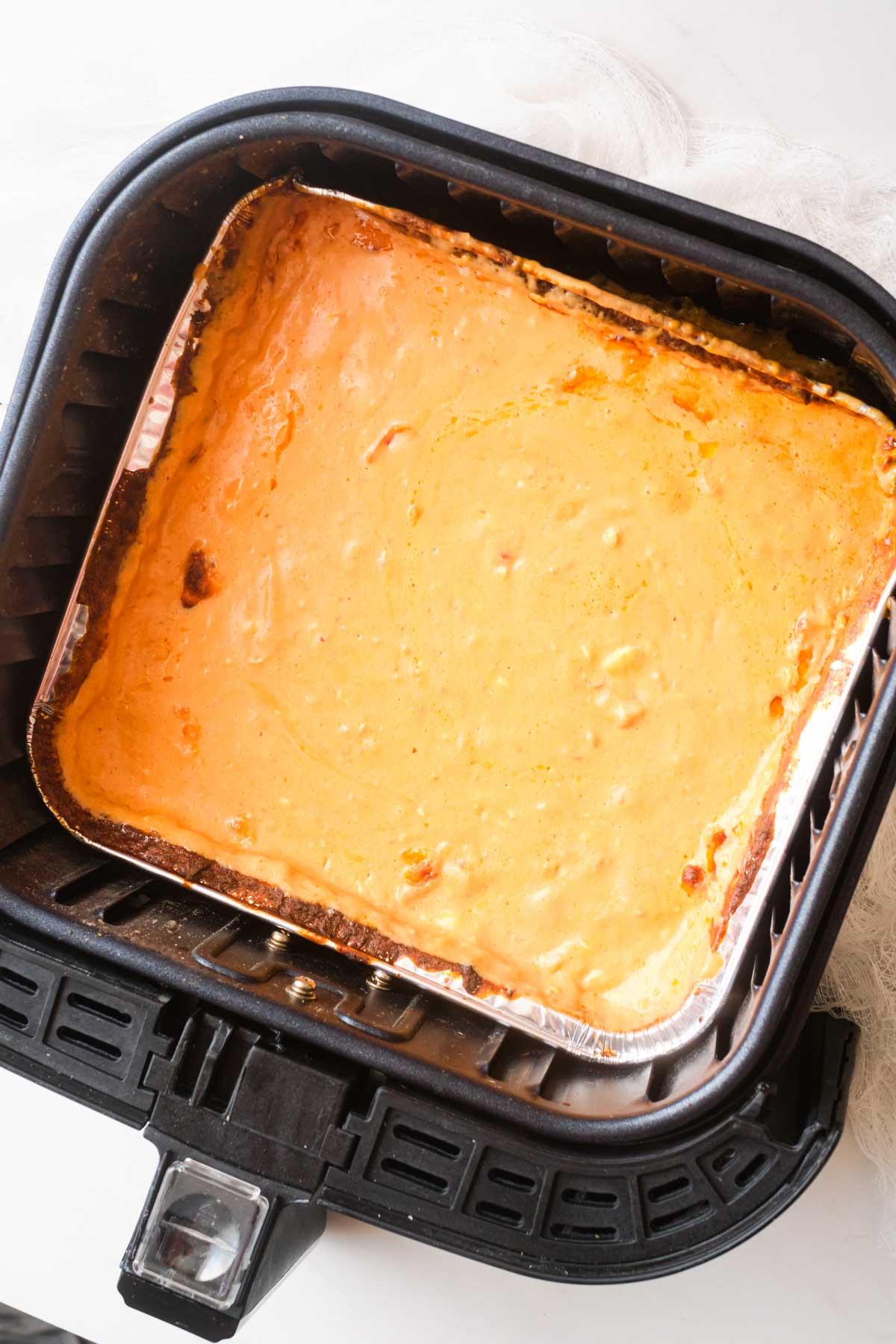 top down view of the finished mexican cheese dip inside the air fryer basket