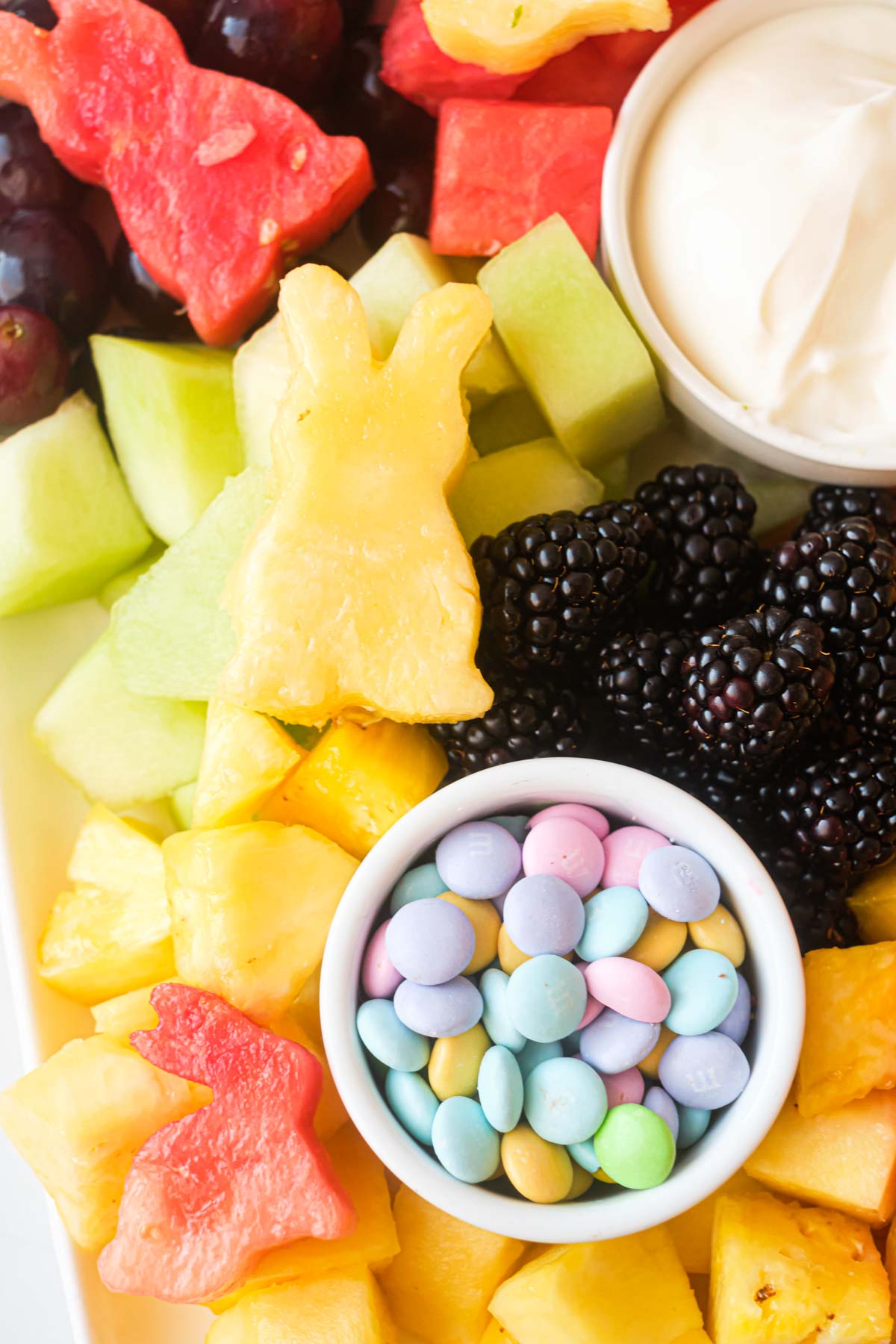 easter egg candies, cut out bunny shapes and yogurt dip assembled on the easter fruit tray