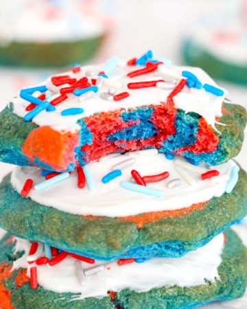 three of the finished air fryer 4th of July cookies stacked vertically with the inside of the top cookie revealed