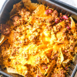 an air fryer basket filled with chili nachos