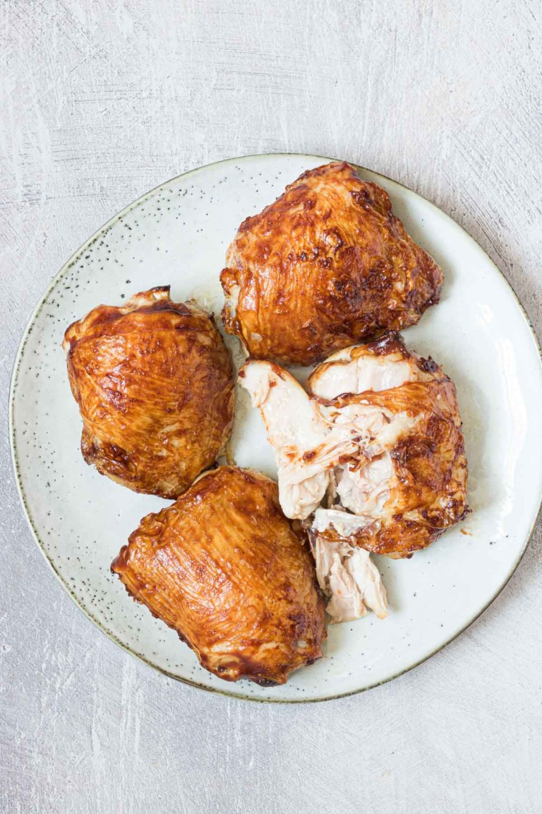 Frozen chicken thighs in air fryer served on a white plate