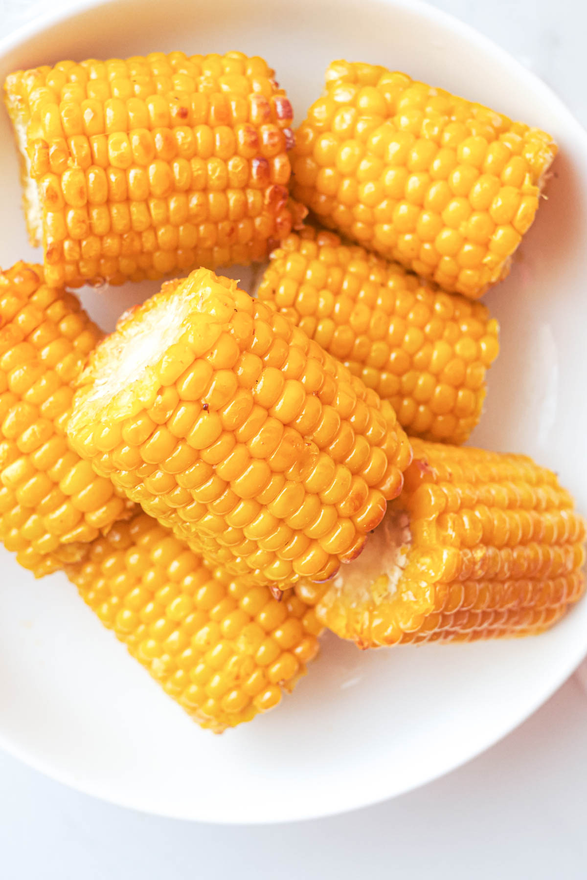 top down view of a plate filled with cooked frozen corn on the cob