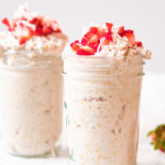 close up of 2 jars of strawberry overnight oats with berries on top