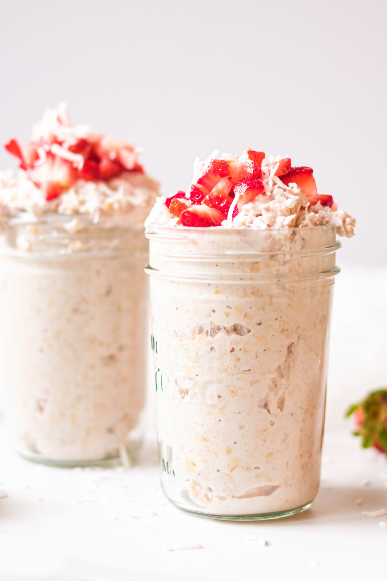close up of 2 jars of strawberry overnight oats with berries on top