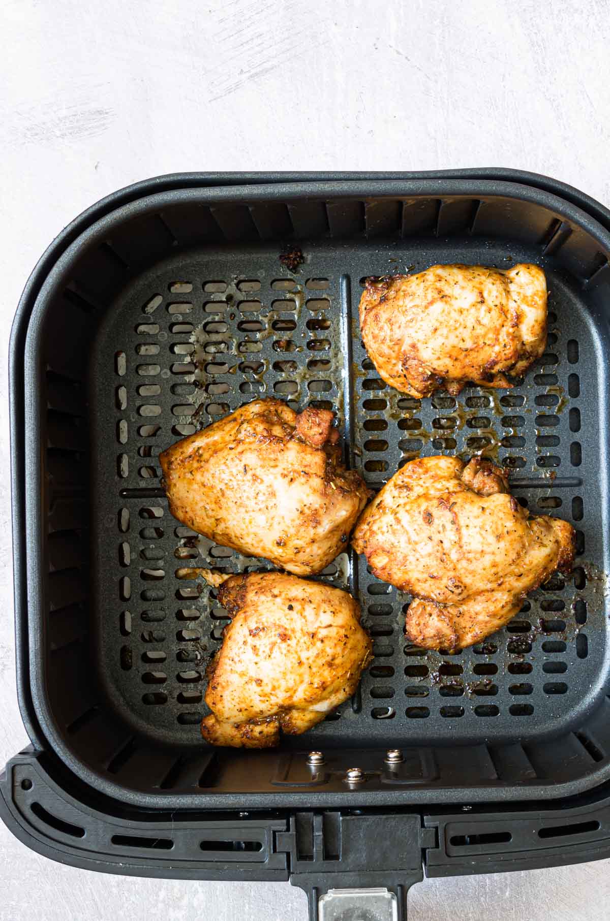 top down view of the completed air fryer boneless chicken thighs inside the air fryer basket