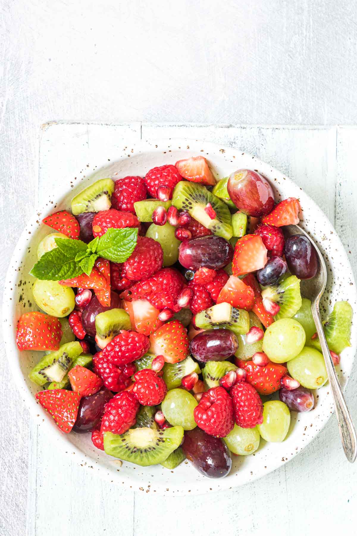christmas fruit salad with a serving spoon inside