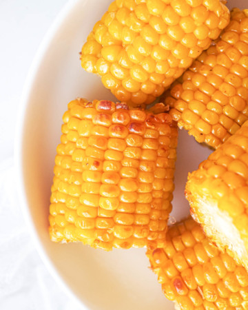 close up view of the completed frozen corn on the cob in air fryer recipe