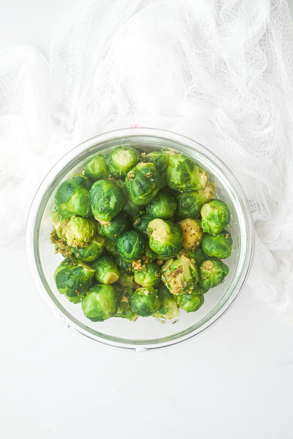 top down view of frozen brussel sprouts in a glass bowl