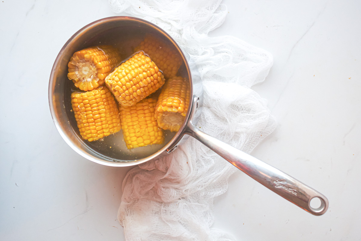 top down view of how to cook frozen corn on the cob on the stovetop