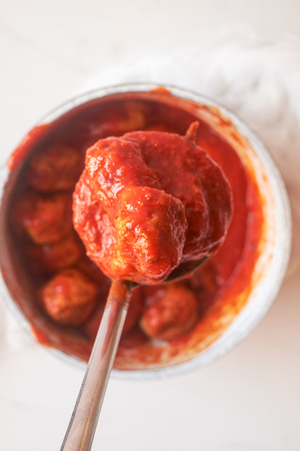 top down view of cooked frozen meatballs in a pan with sauce