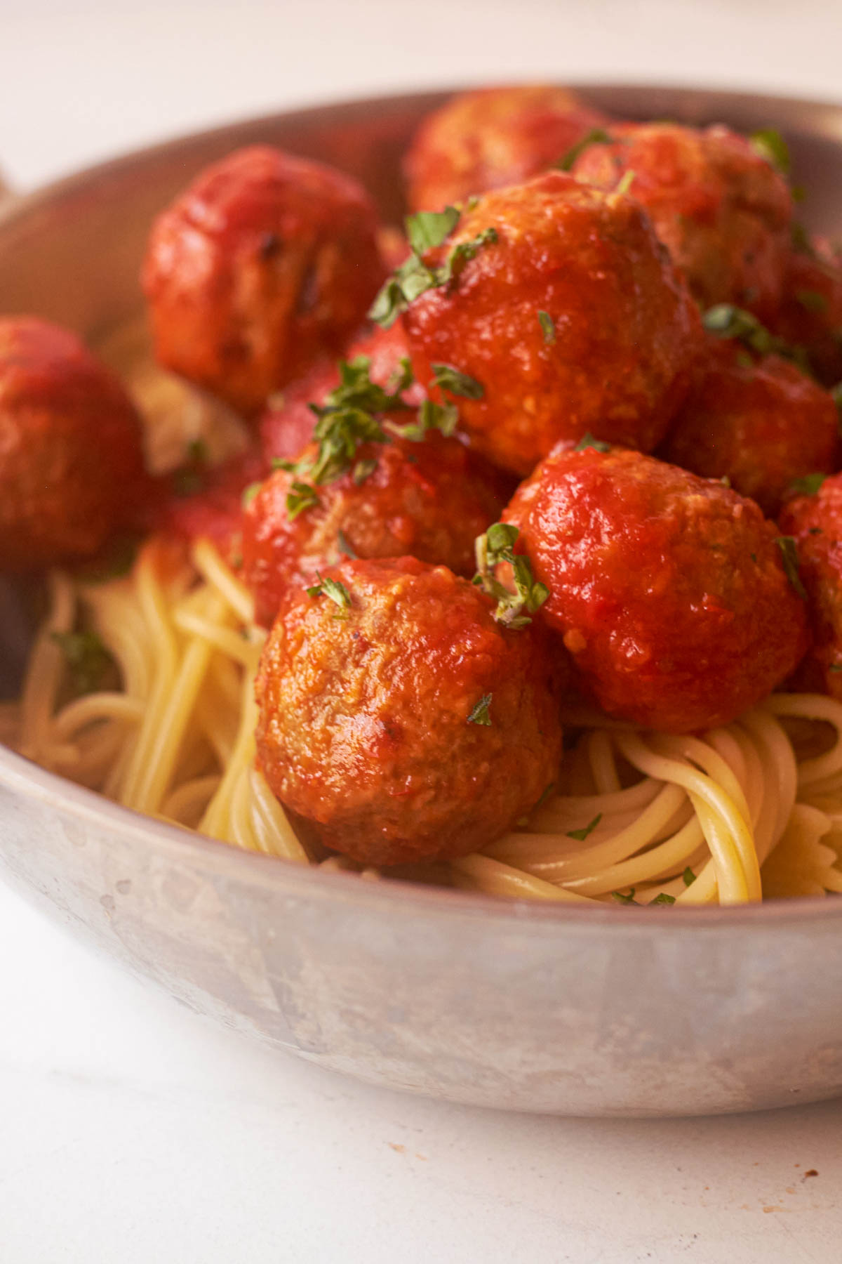 close up of cooked frozen meatballs with pasta and marinara sauce