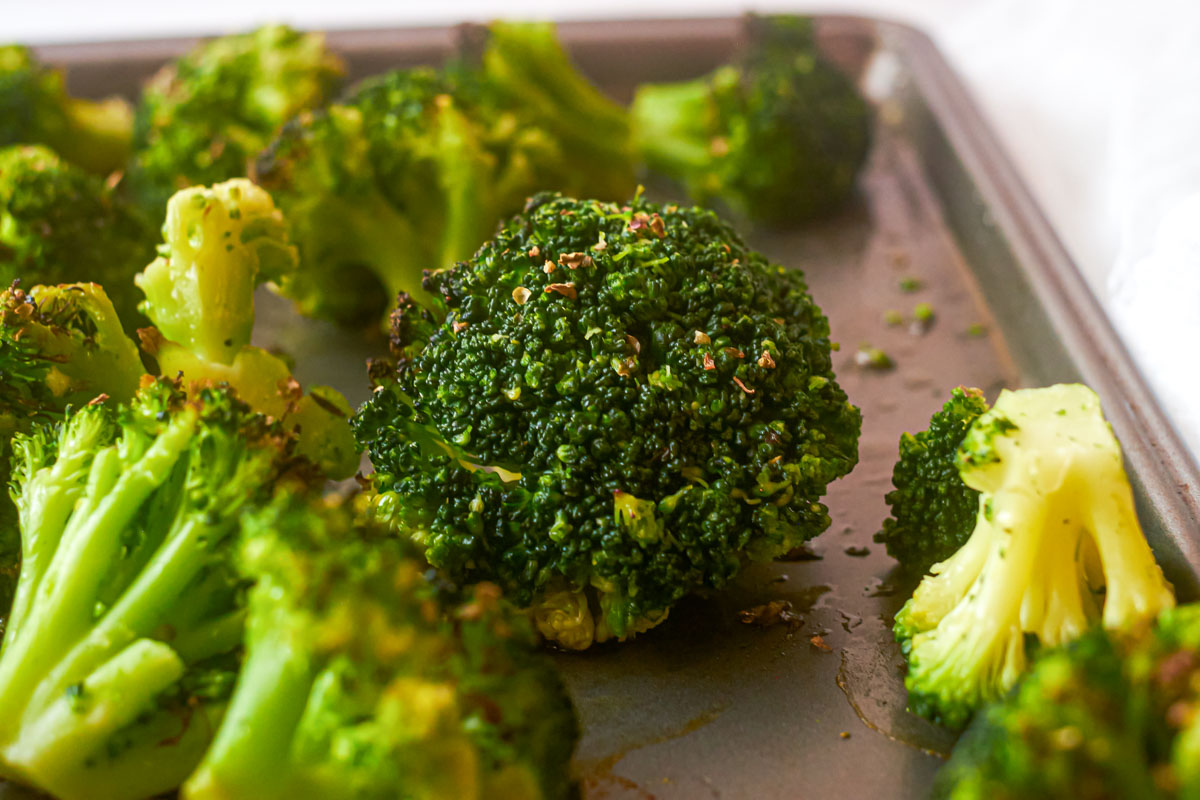 the finished roasted frozen broccoli on baking tray