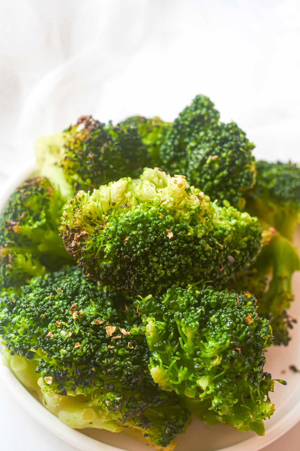 close up view of a plate of roasted frozen broccoli