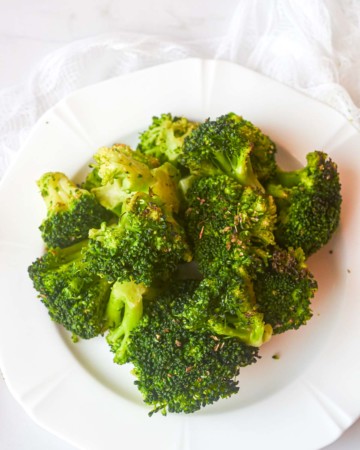top down view of a plate filled with roasted frozen broccoli