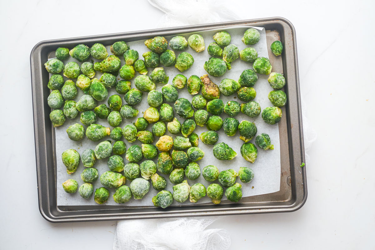roasted frozen brussel sprouts on a baking sheet and ready to be served