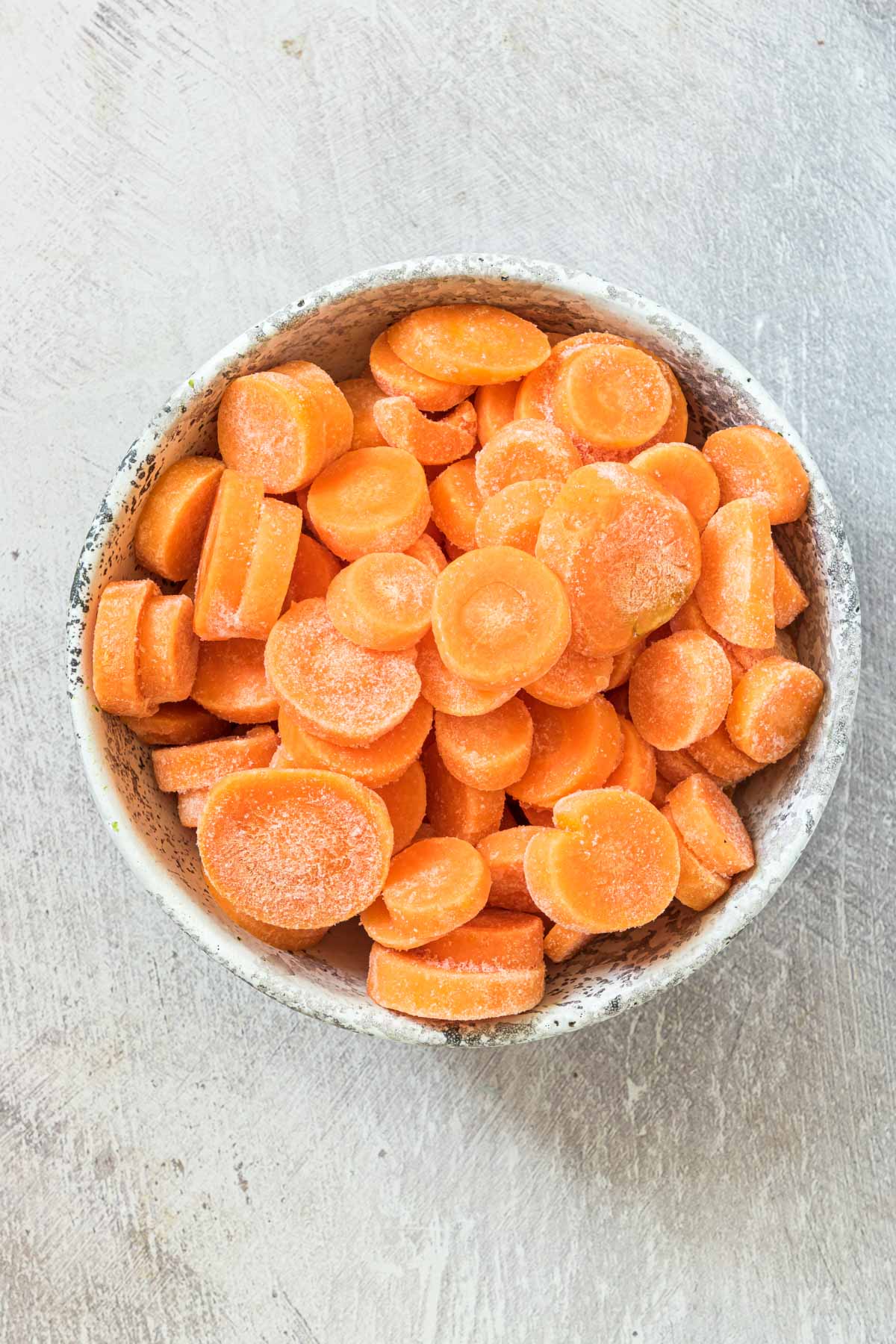 close up view of frozen carrots in a bowl