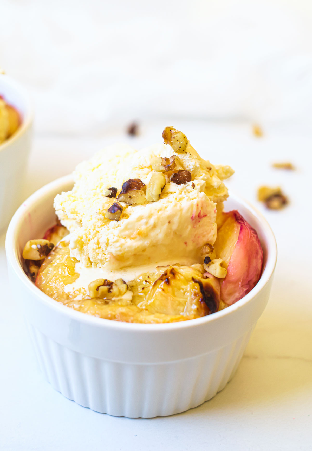grilled peaches served with ice cream and walnuts