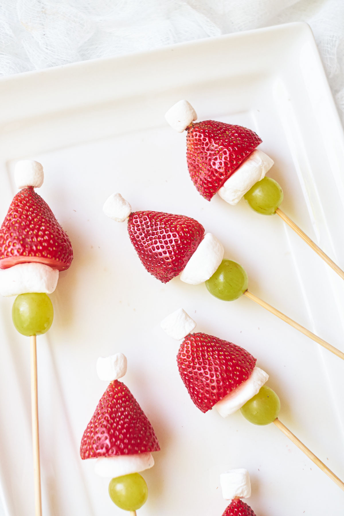 some colorful grinch fruit kabobs for a christmas snack or dessert