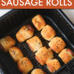 three rows of sausage rolls in an air fryer basket