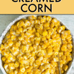 a bowl of creamed corn with a spoon in it