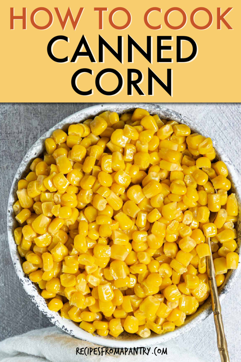 a bowl of cooked corn kernels with a spoon in it