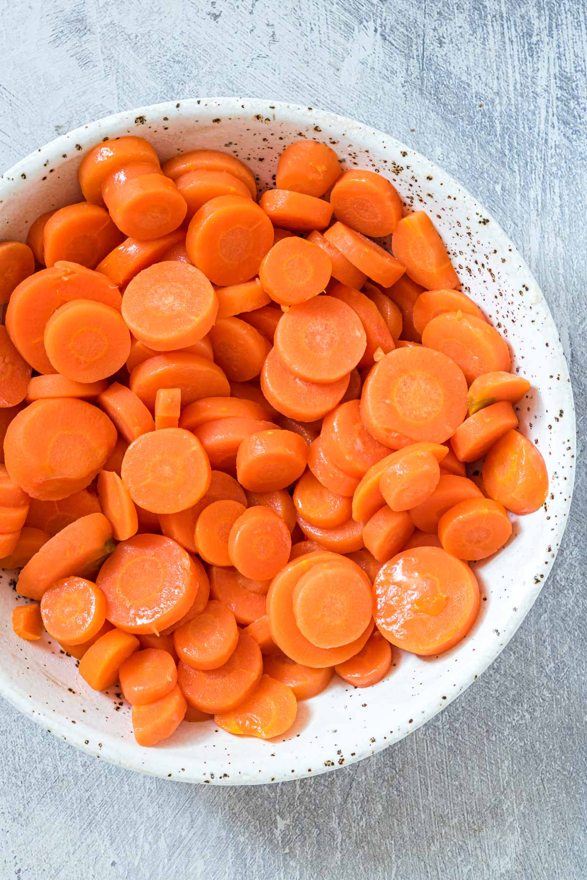 top down view of boiled carrots in a serving bowl
