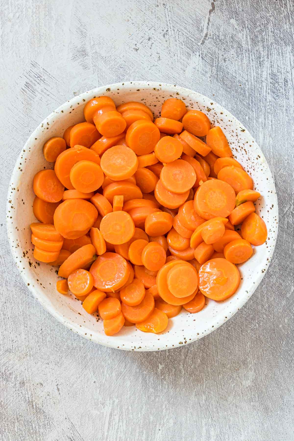 top down view of a bowl filled with boiled carrots